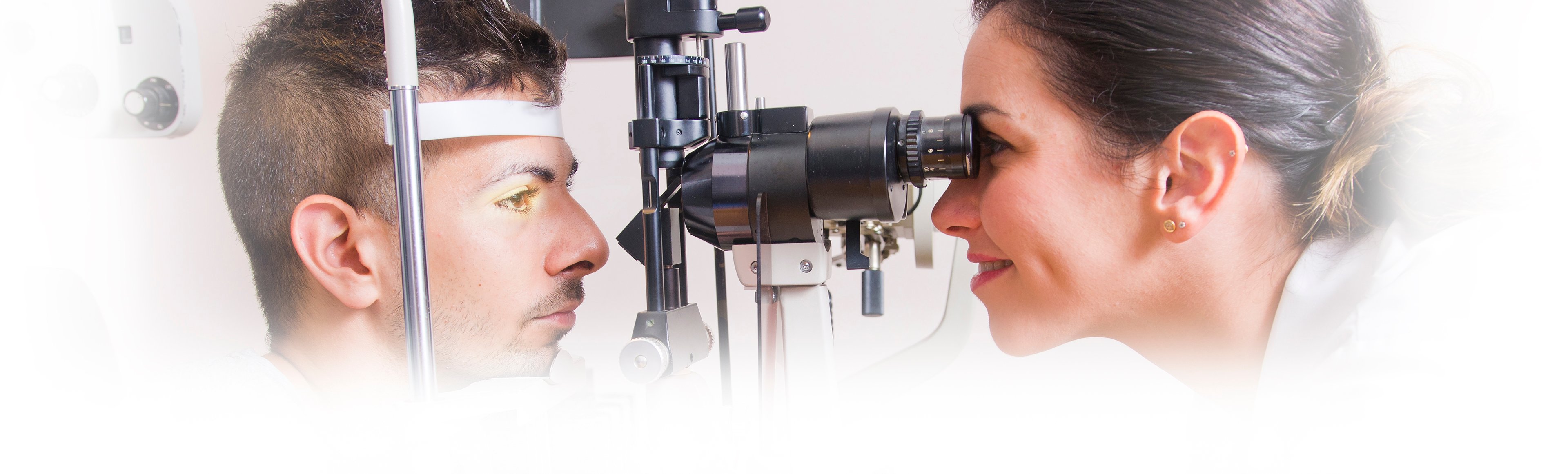 A smiling doctor gives an eye exam